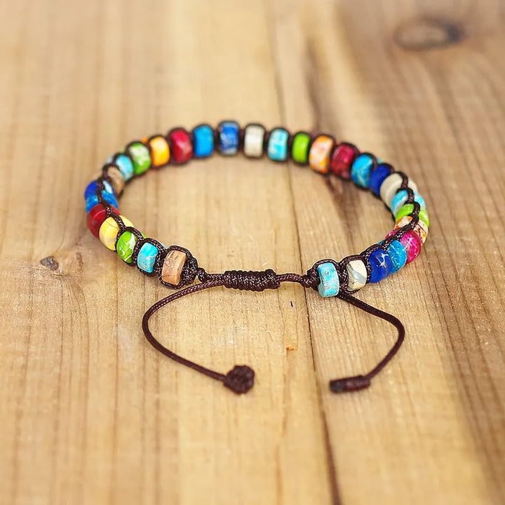 Armband mit sieben Chakren und Natursteinen im böhmischen Stil auf Holz